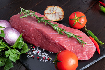 A piece of beef fillet on a black stone plate