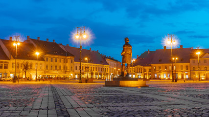 Piata Mare . The main sqaure in the old town of  Sibiu during spring season after sunset . One of the most beautiful city which is Unesco sites of the country , Sibiu , Transylvania , Romania