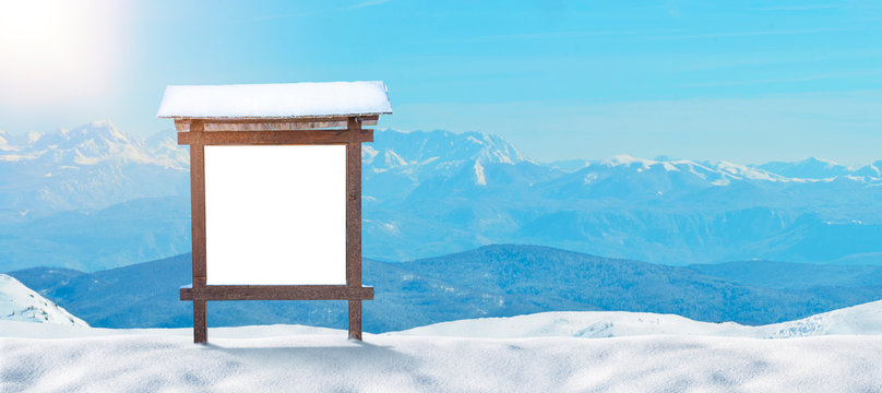 Ski Resort Sign, Billboard Mockup On A Snowy Mountain. Mountain Peaks In The Background. Copy Space Beside.