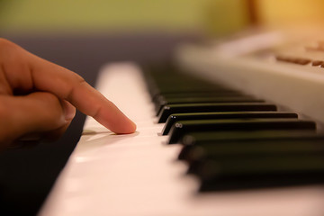Naklejka na ściany i meble Hands pressed down on the piano keyboard.