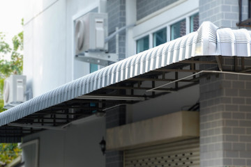 Obraz premium Canvas and galvanized awning in front of the building