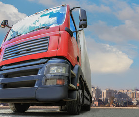 Fototapeta na wymiar Big powerful truck in front of blue bright sky.