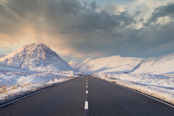 Empty road blank horizon dramatic winter snow at sides in Scottish highlands at Glencoe Rannoch...