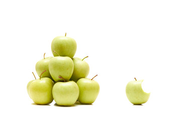 Bitten apple among whole ones