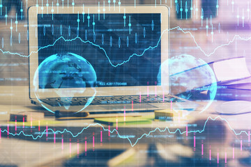 Double exposure of chart and financial info and work space with computer background. Concept of...