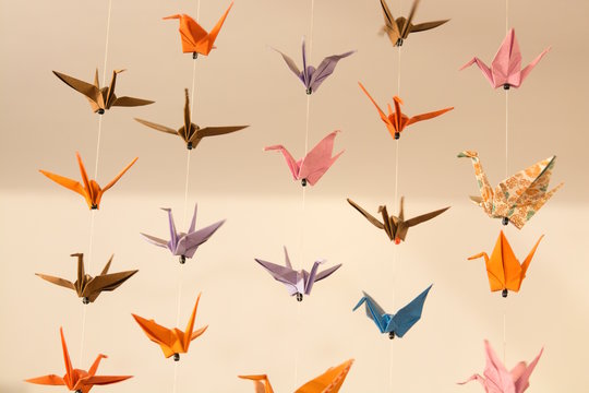 origami crane birds hanging on the threads