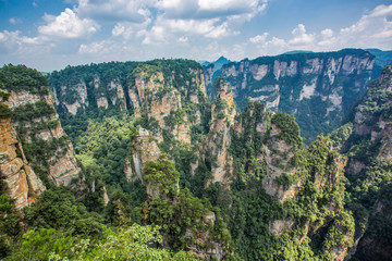  Top view of amazing natural quartz sandstone pillars of fantastic shapes among green woods in the Tianzi Mountains Avatar Mountains, the Zhangjiajie National Forest Park, Hunan Province, China.