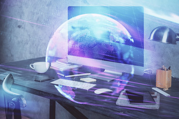 Computer on desktop in office with technology theme hologram. Multi exposure. Tech concept.