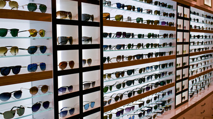 Types of sunglasses, sun glasses on store shelves, optician - obrazy, fototapety, plakaty
