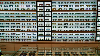 Types of sunglasses, sun glasses on store shelves, optician