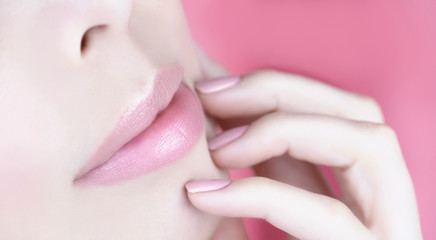 Natural Makeup Look.Natural lip make-up and natural color of manicure. Female lips and fingers close-up.