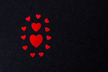 Bright red hearts for lovers on a black background. Happy Valentine's Day.