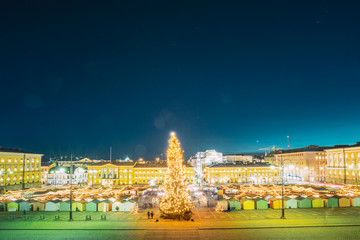Helsinki, Finland. Christmas Xmas Market With Christmas Tree On Senate Square In Evening Night Illuminations.