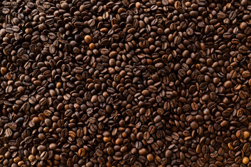 Background filled with a lot roasted coffee beans