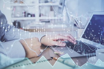Multi exposure of stock market chart with man working on computer on background. Concept of financial analysis.