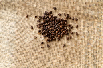 Structured linen background with roasted coffee beans