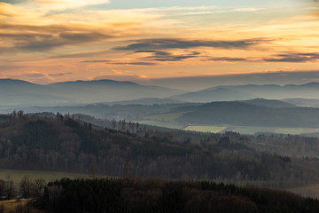 Sunset over hilly landscape of Sumava National Park, meadows and forests in Czech Republic, Central Europe.