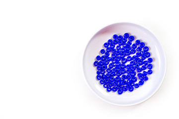 Obraz na płótnie Canvas .Round blue beads for making jewelry shot large on a white background