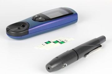 Glucometer. A device for measuring blood sugar levels. Test strips on a uniform background.