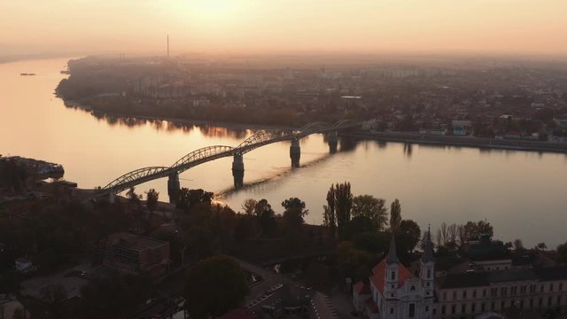 Beautiful wide angle Aerial view of a Bridge over Danube river with Komarno city in background, sunset, Slovakia, Hungary, Europe