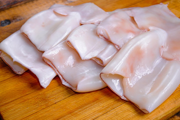 raw squid composition on a wooden background
