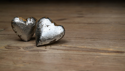 Two hearts on wooden background