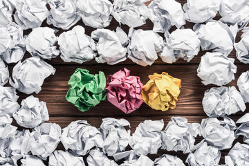 Concept of creativity and inspiration presented by many white paperballs and some color