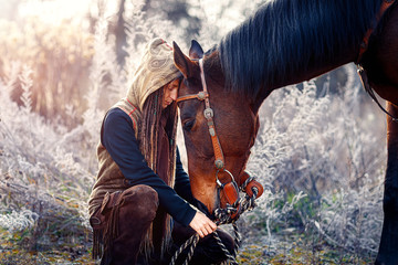 Portrait woman and horse outdoors. Woman hugging a horse.
