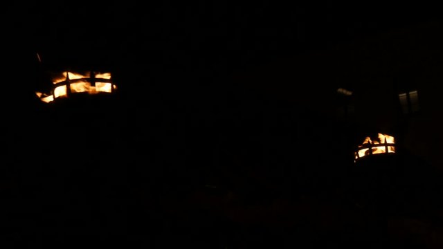 Row of two fire flames in medieval torch on in the dark on a black background