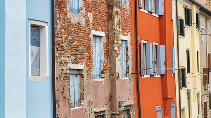 Fototapeta na wymiar Old colorful facades of the buildings in Chioggia, Veneto, Italy