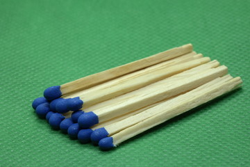 wooden matchsticks on green background