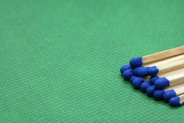 wooden matchsticks on green background