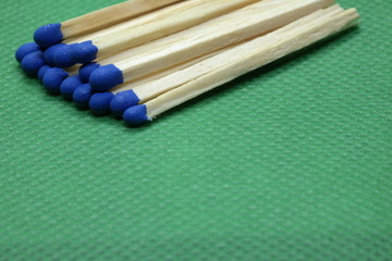 Obraz premium wooden matchsticks on green background