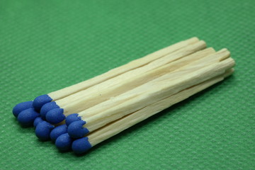 wooden matchsticks on green background