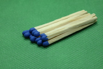 wooden matchsticks on green background