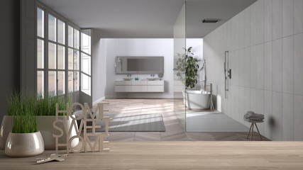 Wooden table, desk or shelf with potted grass plant, house keys and 3D letters making the words home sweet home, over modern white bathroom, interior design, blur background