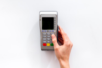 Payments security. Hand enters pin - password - on white background top-down copy space