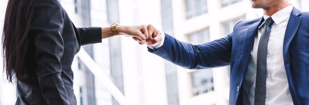Businessman and partner giving fist bump hand