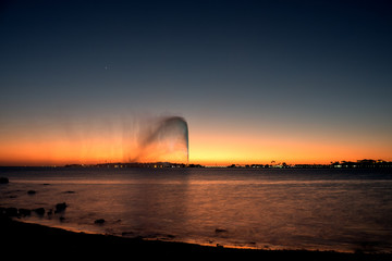 Naklejka na ściany i meble View of the King Fahd's Fountain seen from the South Corniche, Jeddah, Saudi Arabia, with a beautiful sunset in the background