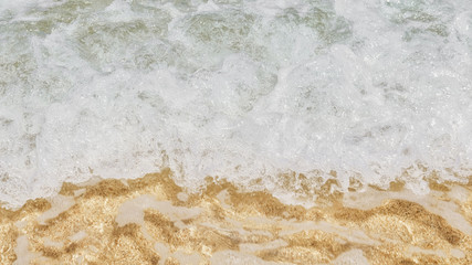 Ocean waves and sand. View from above. Travel background