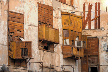 Exterior view of dilapidated traditional residential buildings at the historic district, Al Balad, old city of Jeddah, Saudi Arabia