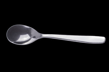 Teaspoon on black isolated background