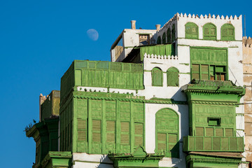 View of the famous greenish Noorwali coral town house at the Souk al Alawi Street in the historic city center of Al Balad, Jeddah, Saudi Arabia