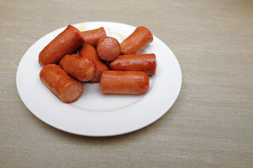 Sliced sausages on white plate