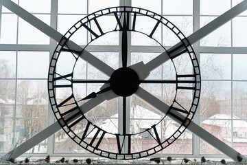 huge mechanical clock on the window in the room