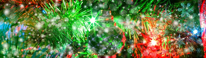 Snowflake New Year winter pattern on blurred defocused background of evergreen tree branch and toys