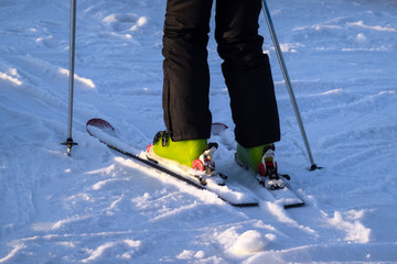 Man skiing in ski resort turing winter season. Person sliding in powder with skis and sticks, having good time