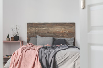 Copy space on empty white wall of rustic bedroom interior