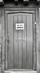 old wooden door with we are open sign 