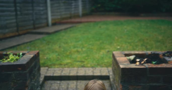 Toddler with grandfather in back garden